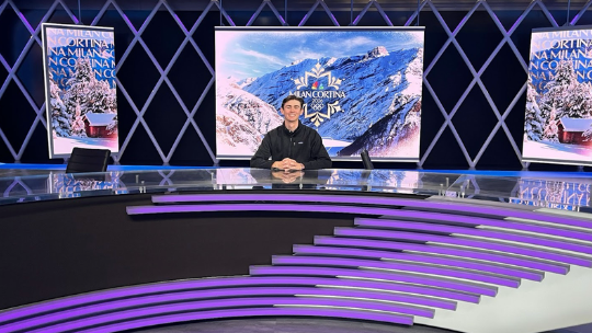 Farrell sits at NBC Sports desk.